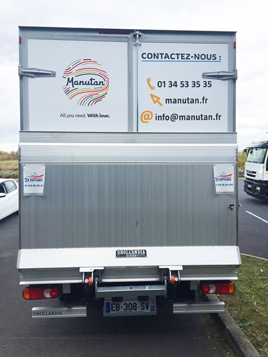 Transport truck seen from behind with Manutan contact details displayed