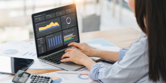 Detailed analysis of financial tables on a laptop to drive a Zero-Based Budgeting (ZBB) strategy.