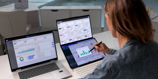 A member of staff analyses financial dashboards to track the inflation impact on business and optimise expenditure management.