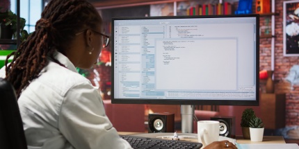 An analyst examines technical data to contribute to TCTO. 