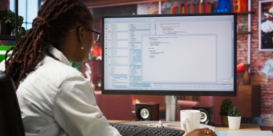 An analyst examines technical data to contribute to TCTO. 