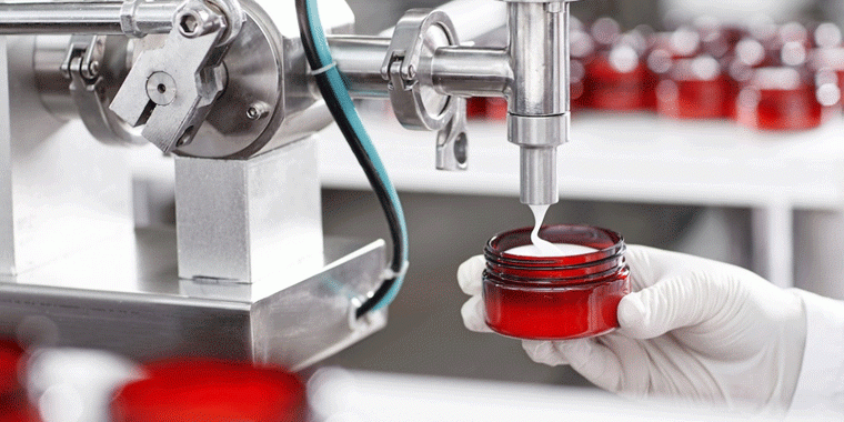 Image of a machine filling a pot of cream