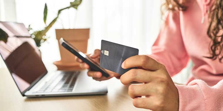 Photo d'une femme tenant une carte bancaire 