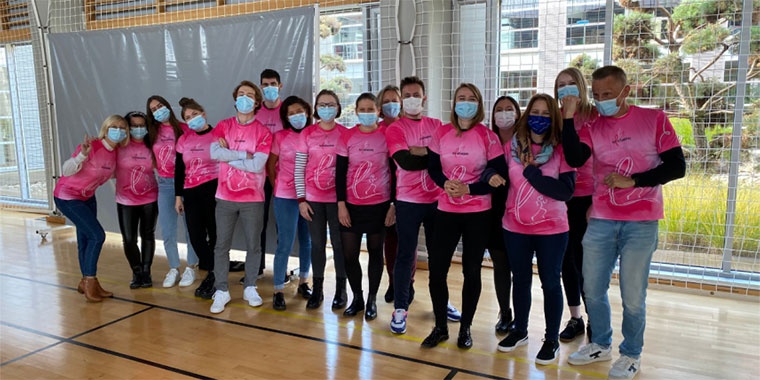 Photo showing sixteen people all wearing pink October t-shirts 