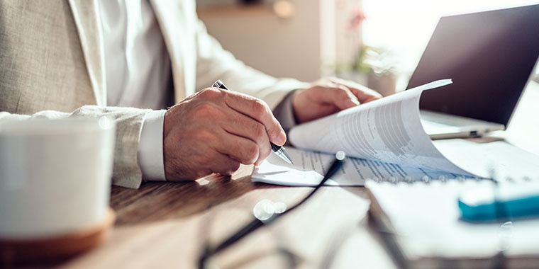 Illustration of a man signing a contract